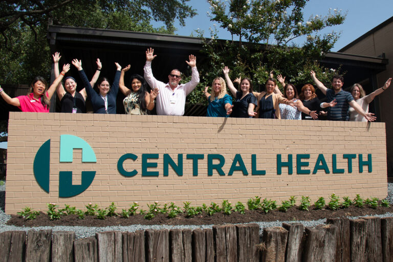 employees behind Central Health sign