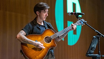 Kelsi Creek playing guitar